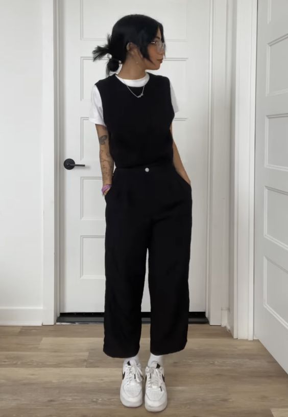 black sweater vest and black pants