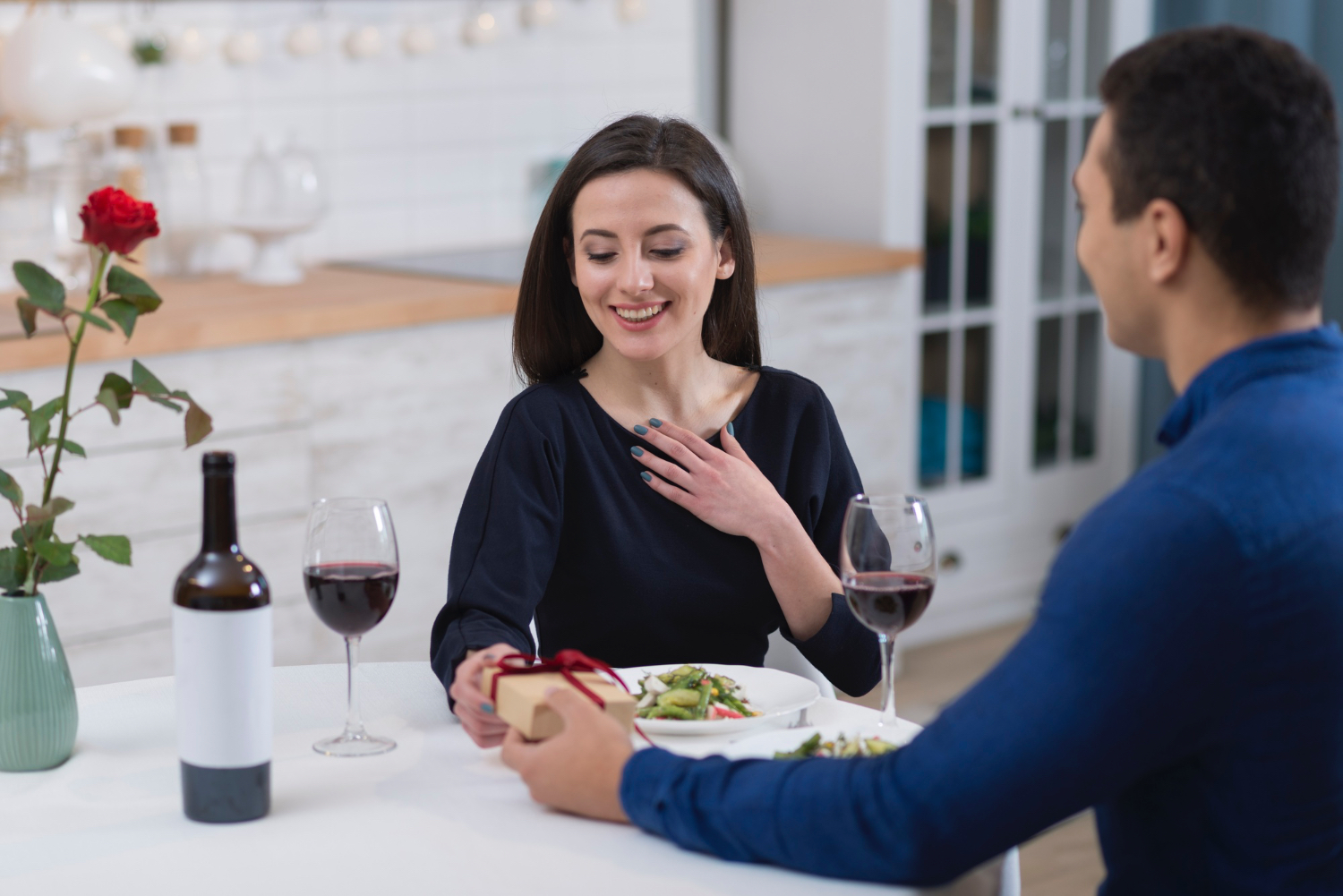 Woman thanking partner while smiling over dinner