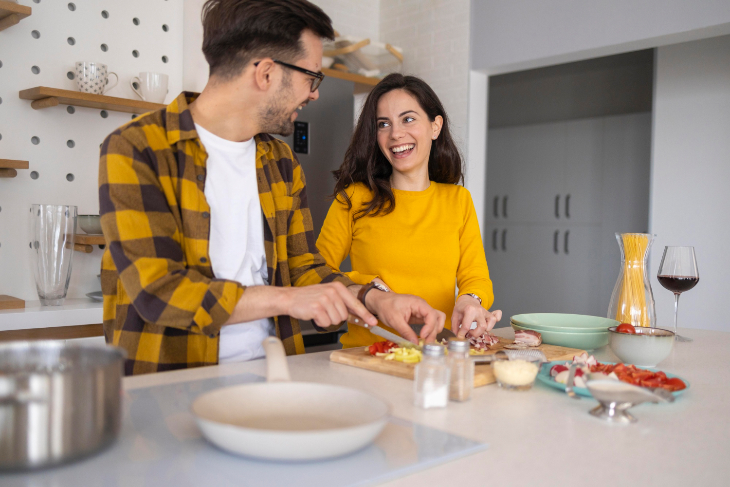 Couple cooking together listening to music
