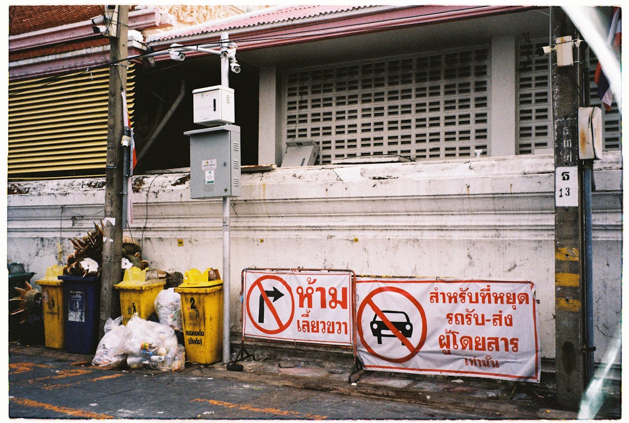 Trash Piled Beside An Empty Dumpster