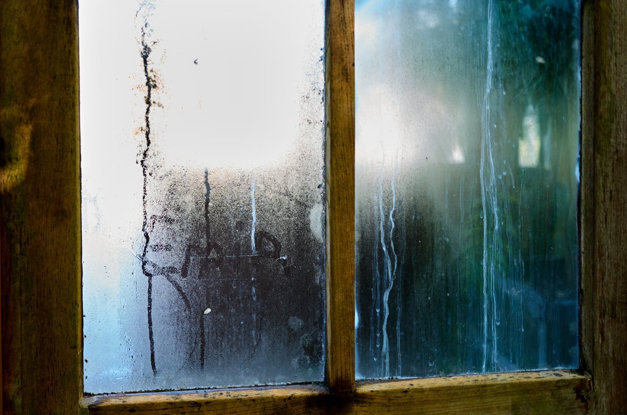 Condensation On Windows And Blackened Sills