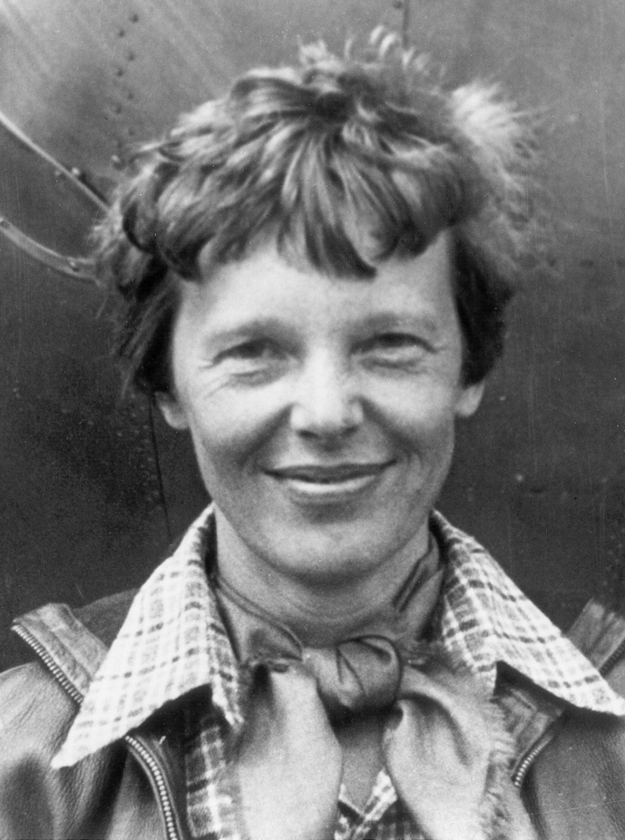 Amelia_Earhart_standing_under_nose_of_her_Lockheed_Model_10-E_Electra,_small_(cropped)